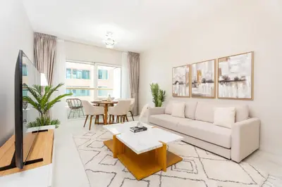 a living room with a white couch and a table at Gala Guests - Elite Sea View Suites Dubai Marina in Dubai