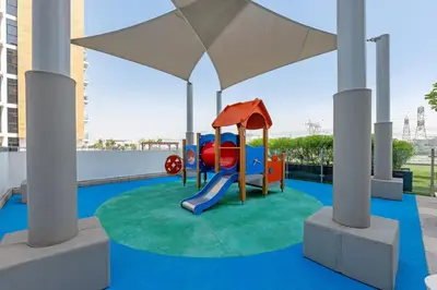 a playground with a slide on a roof at Waves - Stylish and Comfy Couples Retreat Apt with Balcony in Dubai