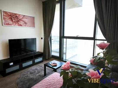 a living room with a television and a large window at 1BHK Pool Sauna 15 Min to Marina in Dubai