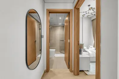 a bathroom with a mirror and a sink at Urban Chic Apartments in Dubai