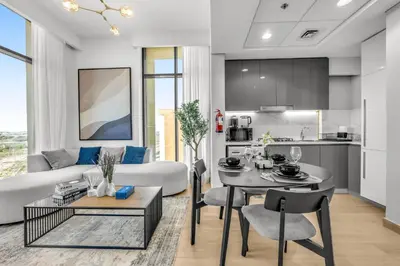 a living room with a couch and a table at Urban Chic Apartments in Dubai