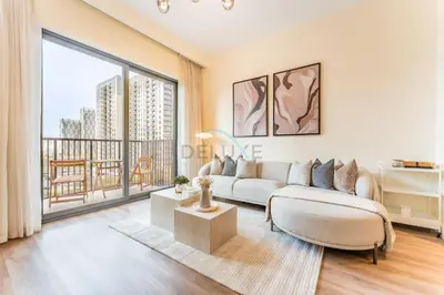 a living room with a couch and a large window at Next to Dubai Hills Park 1BR, Moments from Dubai Hills Mall, Executive Residences 2, Dubai Hills Estate by Deluxe Holiday Homes in Dubai