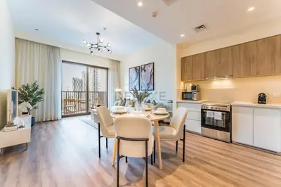 a kitchen and dining room with a table and chairs at Next to Dubai Hills Park 1BR, Moments from Dubai Hills Mall, Executive Residences 2, Dubai Hills Estate by Deluxe Holiday Homes in Dubai