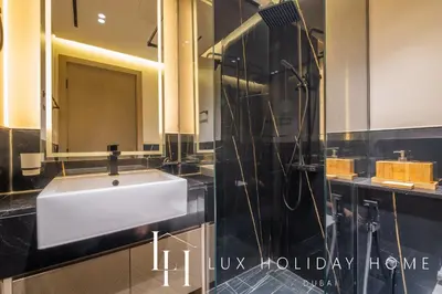 a bathroom with a white sink and a shower at LUX The Modern Binghatti Canal Suite 3 in Dubai