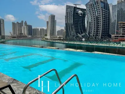 a large swimming pool in the middle of a city at LUX The Modern Binghatti Canal Suite 3 in Dubai