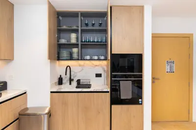 a kitchen with a sink and a cupboard at Premium Apartment mit Strandzugang in Dubai in Dubai