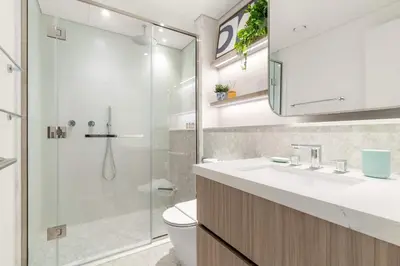 a bathroom with a toilet and a sink and a shower at Silkhaus Chic Studio in Sobha Hartland at Kensington in Dubai