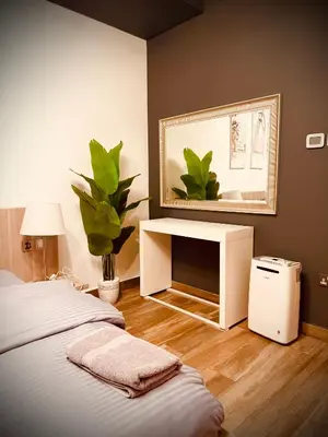 a bedroom with a bed with a desk and a mirror at Luxury Modern Apt in JBR 2 MIN to BEACH in Dubai