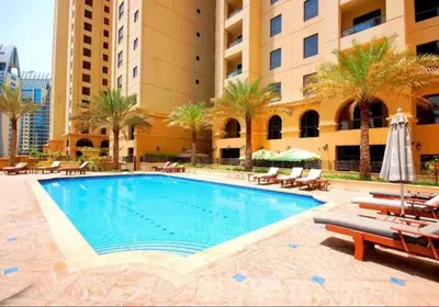 a swimming pool in front of a building at Luxury Modern Apt in JBR 2 MIN to BEACH in Dubai