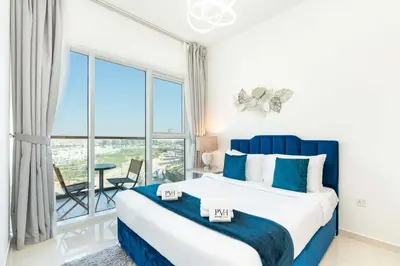 a bedroom with a bed and a large window at PVH - Golf Vita - 1BR with Golf Course View in Dubai