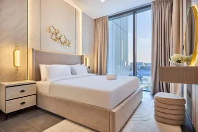 a hotel room with a bed and a large window at STAY BY LATINEM Luxury 1BR Holiday Home CA 0906 Near Burj Khalifa in Dubai