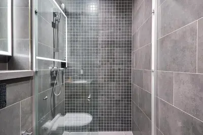 a shower with a glass door in a bathroom at STAY BY LATINEM Luxury 1BR Holiday Home CA 0906 Near Burj Khalifa in Dubai