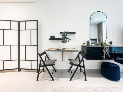 a room with two chairs and a mirror at Modern Studio with Private Jacuzzi in Dubai