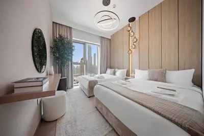 a hotel room with two beds and a window at Serene 2BR Burj View DT Dubai in Dubai