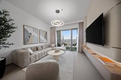 a living room with a couch and a flat screen tv at Serene 2BR Burj View DT Dubai in Dubai