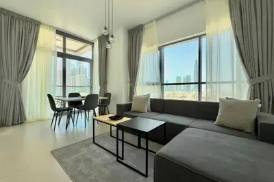 a living room with a couch and a table at 1 Bedroom Apt with Stunning Burj Khalifa View in Dubai