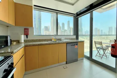 a kitchen with a view of a city skyline at 1 Bedroom Apt with Stunning Burj Khalifa View in Dubai