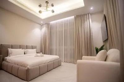 a bedroom with a large bed and a couch at Luxury 5 Bedroom Villa Nad Al Sheba in Dubai