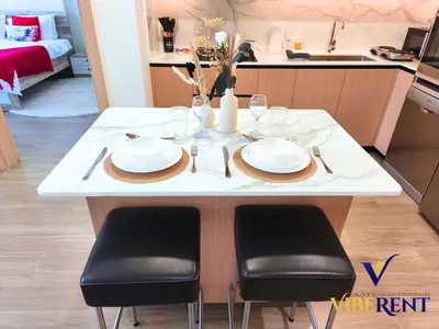 a table with plates and napkins on it in a kitchen at Explore Dubai from Aura - 2BHK in Dubai