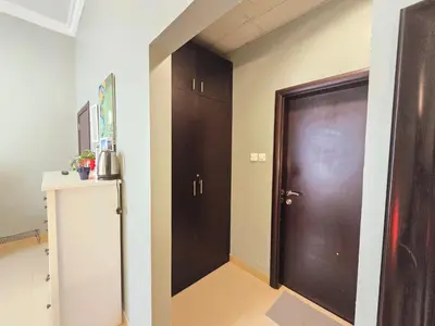 a hallway with a brown door in a room at Airy and Bright Near DIFC and the Subway in Dubai