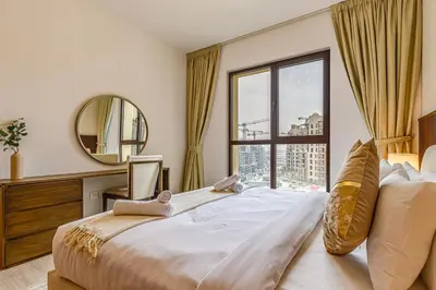 a bedroom with a large bed with a large window at Elegant 2 Bedroom Apartment - Jadeel 2, Madinat Jumeirah - Allsopp & Allsopp in Dubai