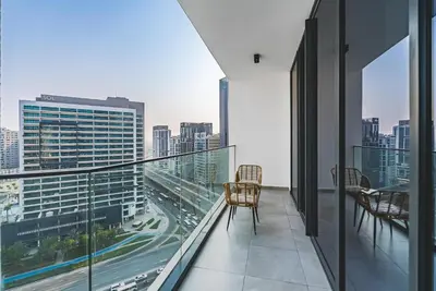 a balcony with chairs and a view of a city at Escape24 Brand New 1BR with City View near Burj Khalifa in Dubai