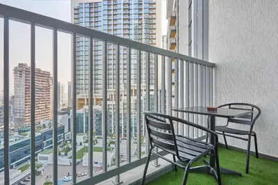 a balcony with a table and chairs and a view of a city at STAY BY LATINEM Luxury 1BR Holiday Home CA 1506 Near Burj Khalifa in Dubai