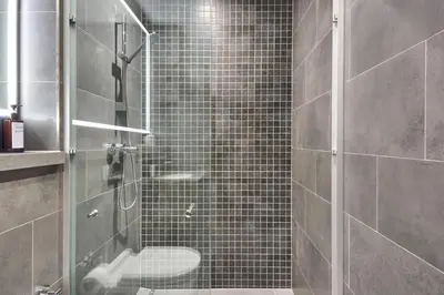 a bathroom with a glass shower with a toilet at STAY BY LATINEM Luxury 1BR Holiday Home CA 1506 Near Burj Khalifa in Dubai