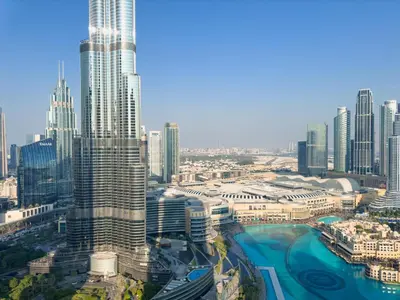 an aerial view of a city with tall buildings at GRANDE RESIDENCES with a direct Burj Khalifa view and Private Fountain Show at 62nd floor with DXB AIRPORT VIP Shuttle option for 8 guests in Dubai