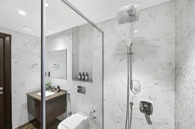 a bathroom with a shower and a toilet and a sink at Unwind in a Stylish Studio with Pool, Sauna, and Stunning City Views in Dubai
