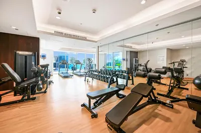 a gym with a lot of treadmills and machines at Unwind in a Stylish Studio with Pool, Sauna, and Stunning City Views in Dubai