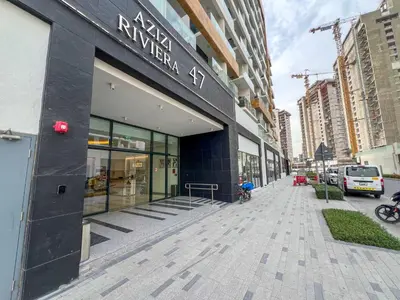 a building on a street in a city with at 1BR Royal Bedroom with Pool & Gym Free in Dubai