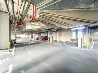 an empty parking lot in a parking garage at 1BR Royal Bedroom with Pool & Gym Free in Dubai