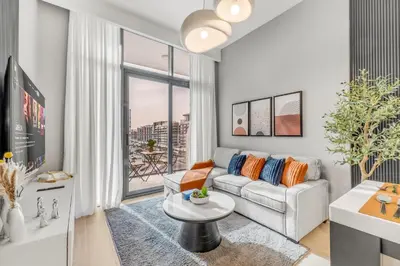 a living room with a couch and a table at 1BR Royal Bedroom with Pool & Gym Free in Dubai