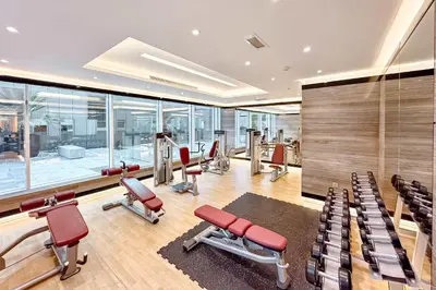 a gym with cardio equipment in a building at PVH - Refined 1BR in Business Bay - Cour Jardin in Dubai