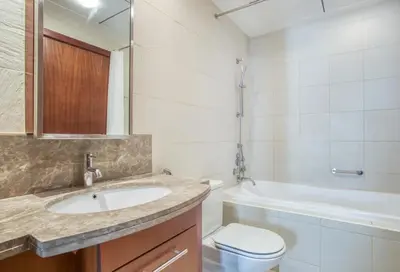 a bathroom with a sink and a toilet and a tub at Stylish 1BR in Downtown - 5 Min to Burj & Mall in Dubai