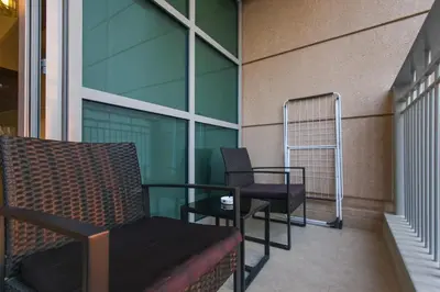 a balcony with a chair and a table on a building at Stylish 1BR in Downtown - 5 Min to Burj & Mall in Dubai