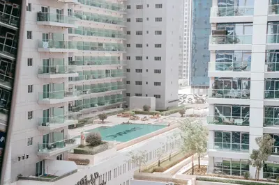 an aerial view of a building with a swimming pool at Stylish Stay with Rooftop Pool and Gym, Close to Dubai's Top Sights in Dubai