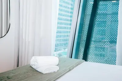 a hotel room with a bed and a window at Stylish Stay with Rooftop Pool and Gym, Close to Dubai's Top Sights in Dubai