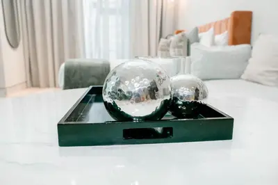 two glass balls on a black tray on a table at Stylish Stay with Rooftop Pool and Gym, Close to Dubai's Top Sights in Dubai