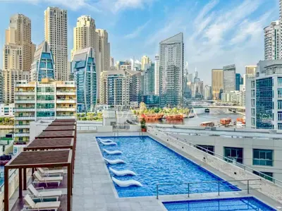a swimming pool on the roof of a building with a city skyline at Barsana - Lavish 3BR Retreat - Marina & Sea Views in Dubai