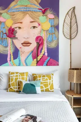 a bedroom with a bed with a painting of a woman at The Smart Concierge - Marina view in Dubai