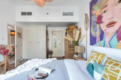 a bedroom with a bed and a painting on the wall at The Smart Concierge - Marina view in Dubai