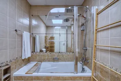 a bathroom with a large tub and a shower at The Smart Concierge - Marina view in Dubai