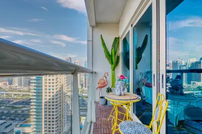 a balcony with a table and a view of a city at The Smart Concierge - Marina view in Dubai