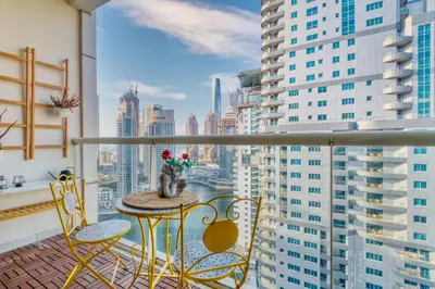 a balcony with a table and chairs and a view of a city at The Smart Concierge - Marina view in Dubai