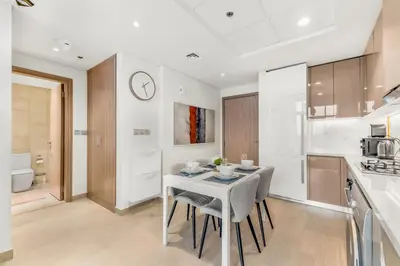 a kitchen and dining room with a table and chairs at Elite Apartments in Meydan in Dubai