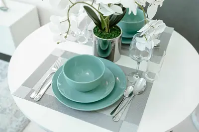 a table with blue plates and silverware on a table at PVH - Serene Studio with Skyline View - Carson B in Dubai