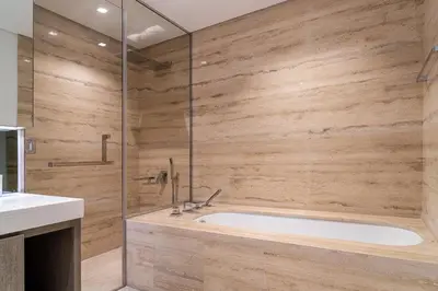 a bathroom with a tub and a glass shower at Luxury 1 BR At The Sterling in Dubai