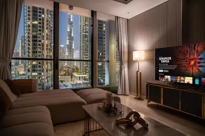 a living room with a couch and a large window at Luxury 1 BR At The Sterling in Dubai
